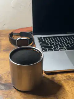 metal cup on desk with laptop