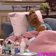 Alf sick in bed with medicine