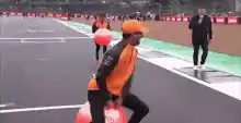 Formula 1 grid girl slips on wet track