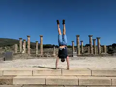 man handstand split ancient ruins