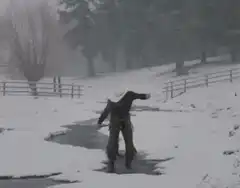 Cowboy slips on ice in snow