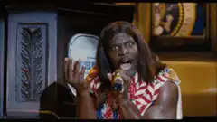 Terry Crews singing passionately into a microphone