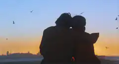 Couple hugging at sunset