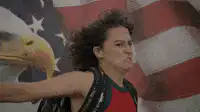 Woman saluting with intense expression