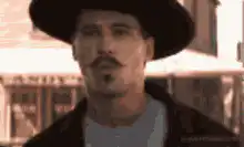 Man in hat tips his hat