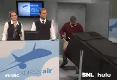 Man struggles with giant suitcase at airport