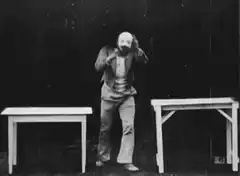 Man pulls off mask to reveal face