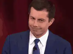 Pete Buttigieg smirking and looking down