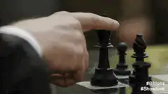 Hand knocks over chess king