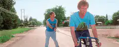 Bobby Hill being towed on a bike