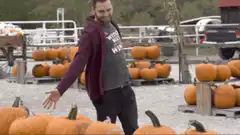 Man dancing among pumpkins