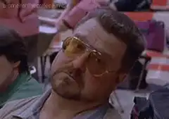 John Goodman squinting in yellow sunglasses
