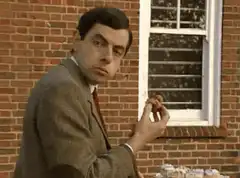 Mr. Bean eating a cupcake