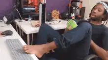 man typing on keyboard with feet