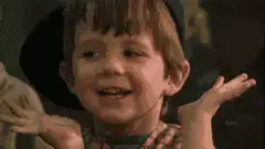 Boy shrugs then smiles