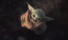 Baby Yoda hugging itself