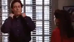 Jerry Seinfeld puts on a jacket