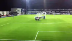 people moving soccer goal on field
