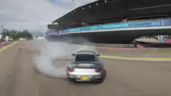 Silver Porsche drifting on race track
