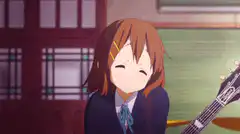 Yui smiling with guitar