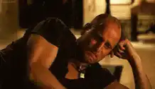 Bald man wipes face with money