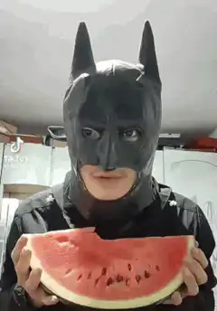 Batman eating watermelon