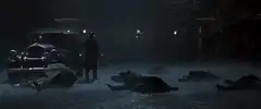 Batman stands over fallen mobsters