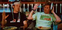 Two men high-fiving at a table