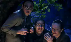 Three men laughing in the woods