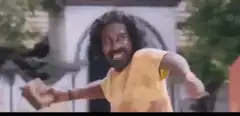 Man in yellow shirt throwing brick