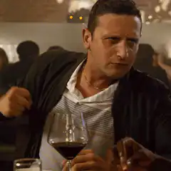 Man drinking wine and pointing