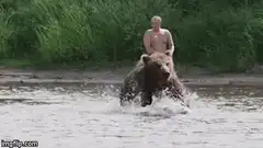 Man riding a bear through water