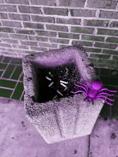 Color changing toy spider on planter