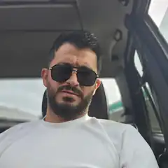 man in car with sunglasses
