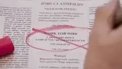 Hand circling lawn care ad with pink marker