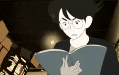 Boy reading book that glows bright