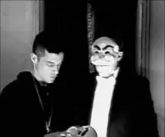 Two men put on creepy masks