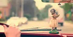 Hula dancer bobblehead in car