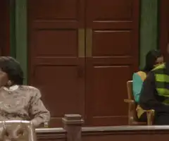 Man enters courtroom in grey suit