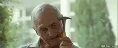Old man holding hammer to head