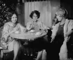 Three women drinking tea and smoking