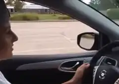 Passenger grabs driver's arm in car