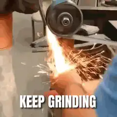Hand under spinning grinder sparks