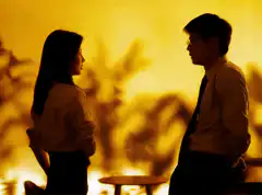 Woman whips man with a belt