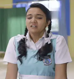 Girl in school uniform crying
