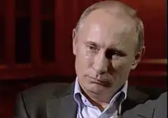 Vladimir Putin laughing and wiping tears