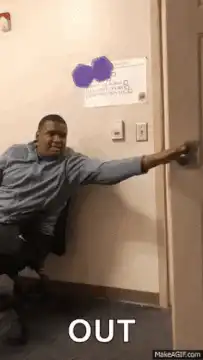 Man in chair pointing at light switch
