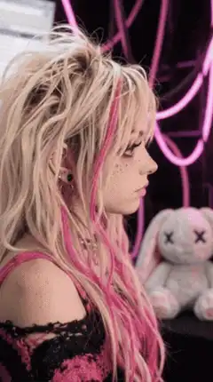 girl with pink hair blowing bubblegum