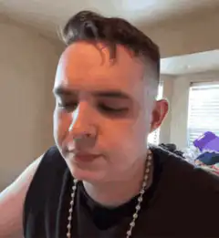 man eating a burger with intense expression