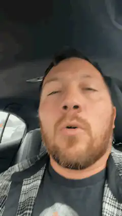 man singing in car